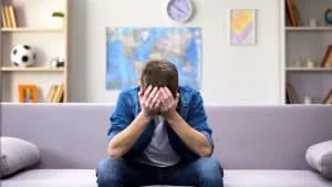 Image of a man sitting on a couch with head in hands. There are stress management techniques you can use at home. An anxiety therapist in North Carolina can help whether you are in Raleigh, Asheville or anywhere else in North Carolina. Reach out to learn about anxiety treatment in Asheville, North Carolina.