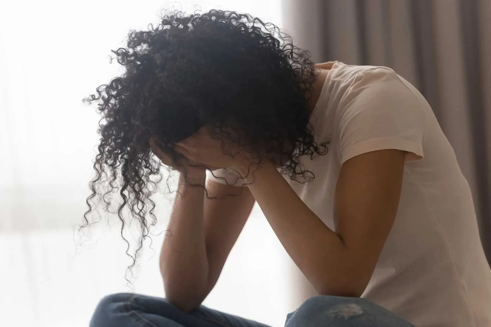 a person with her head in her hands