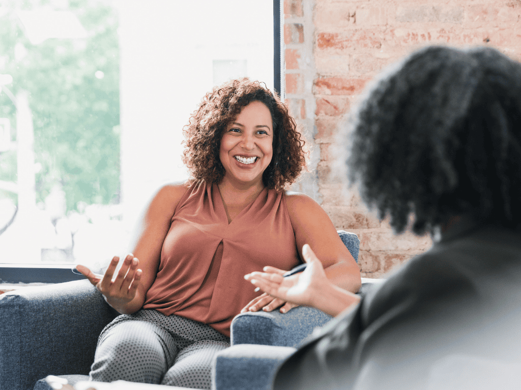 a woman talking to a black therapist - mental health counseling