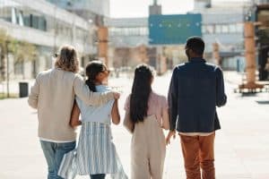 Image of four diverse friends walking away together. Would you like to find a "black therapist near me" in Asheville, NC? Then you have come to the right spot for BIPOC mental health resources. With multicultural counseling we support BIPOC mental in Asheville, Wilmington, Charlotte & everywherein North Carolina. Call today to start online therapy in North Carolina!