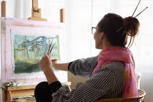 Image of a woman painting with paint brushes in her hair. Are you wondering if there is support for neurodivergent symptoms in Wilmington, North Carolina? Our NC therapists are here to help you understand you neurodivergence. If you are neurodivergent and want support in Wilmington or anywhere in North Carolina we can help. Reach out today!