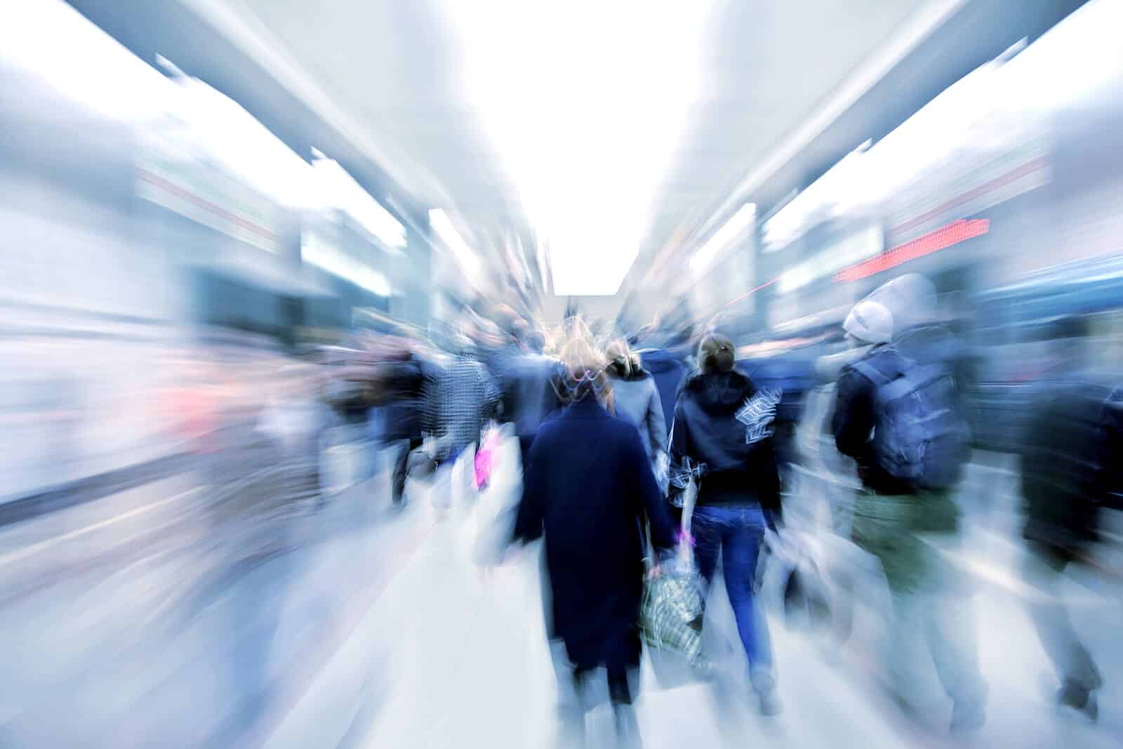 A blurred image of people walking in the city. Is the state of the world causing you stress symptoms in Charlotte, North Carolina? This can decrease your mental health but online therapy