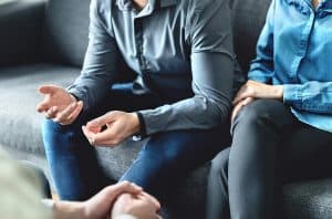 Image of a couple meeting with a marriage counselor for couples therapy in North Carolina. It is possible to repair the space between your and your partner with marriage counseling.