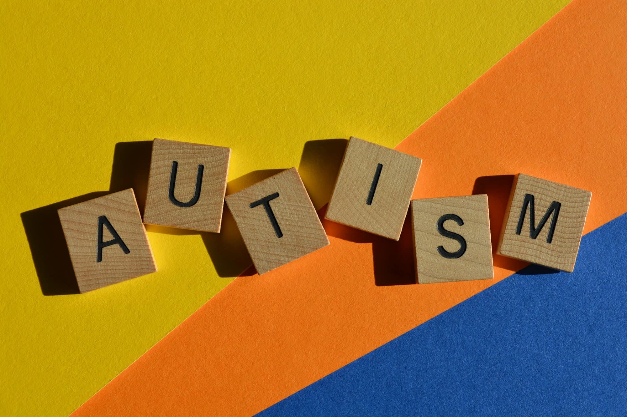 Autism, word in 3D wooden alphabet letters in crossword form